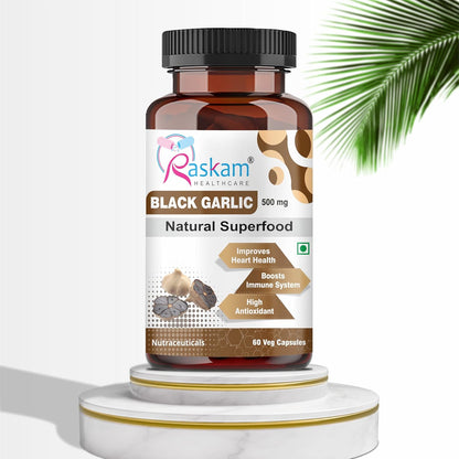 Bottle of Raskam Black Garlic capsules on a white background with a palm leaf.