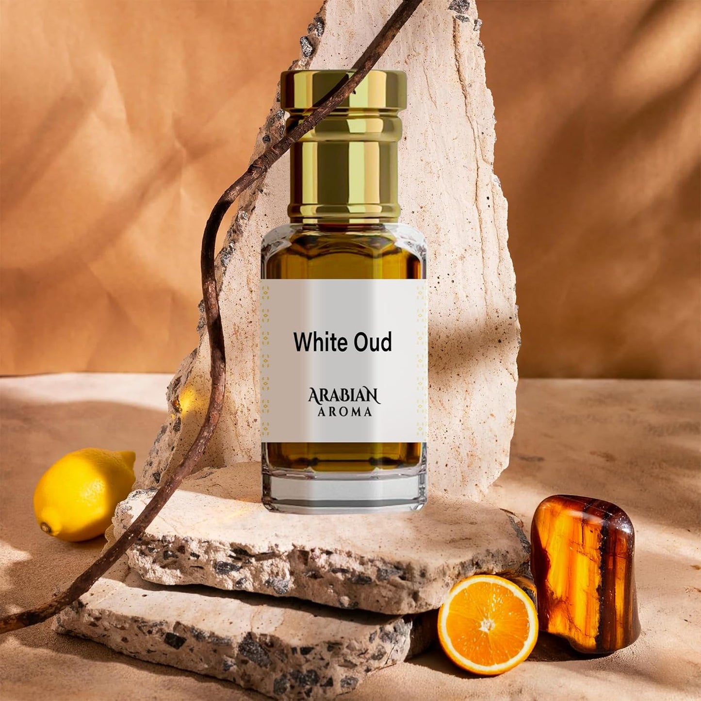 White Oud perfume bottle by Afnan on a stone surface with fruits