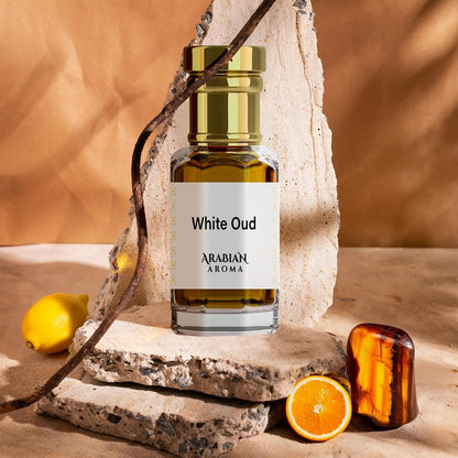 White Oud perfume bottle by Afnan on a stone surface with fruits