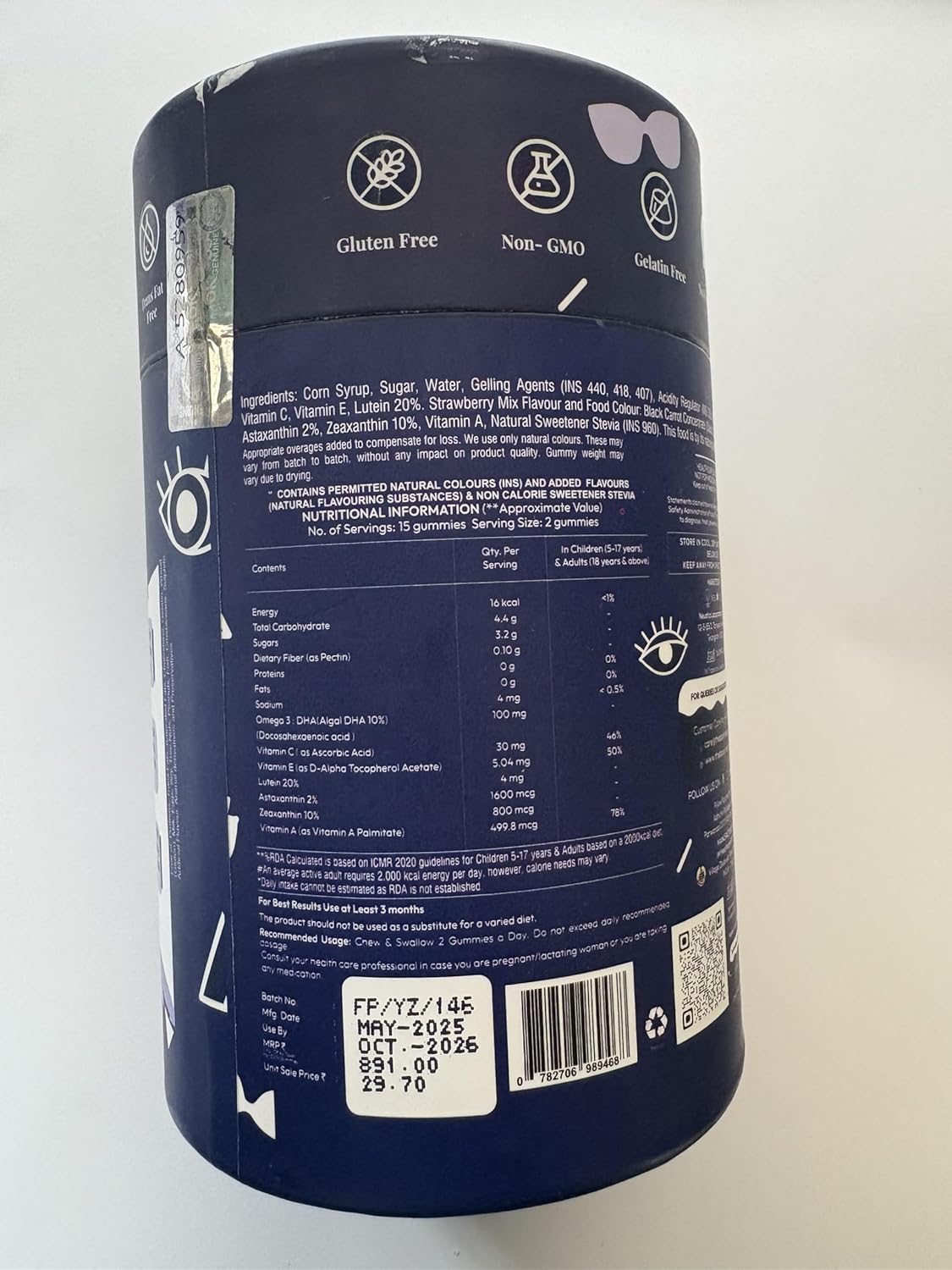 Back view of a blue container with nutritional information and labels on a white background