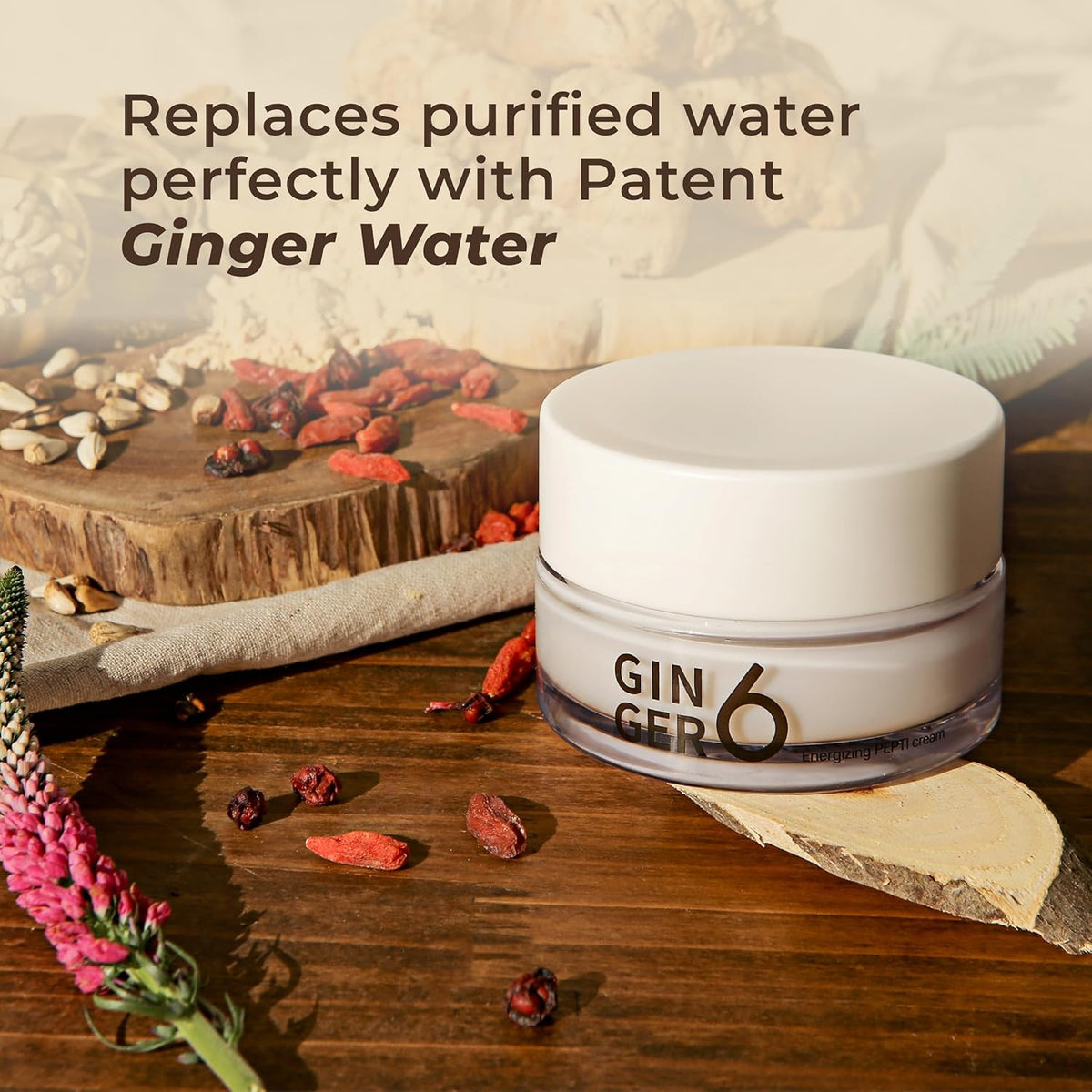 Jar of 'GIN GER6' on a wooden surface with dried ginger and flowers.