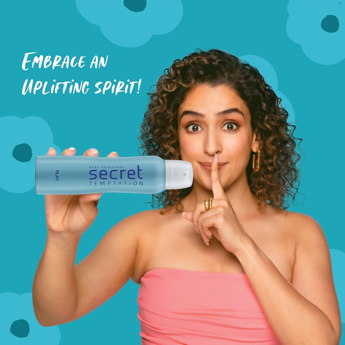 Woman holding a Secret Temptation product with a blue background and text 'Embrace an Uplifting Spirit'.