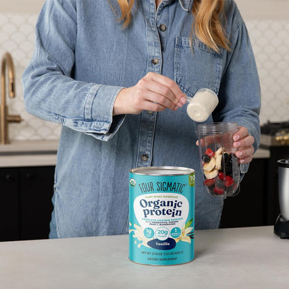Person preparing a protein shake with Four Sigmatic Organic Protein can in the foreground.