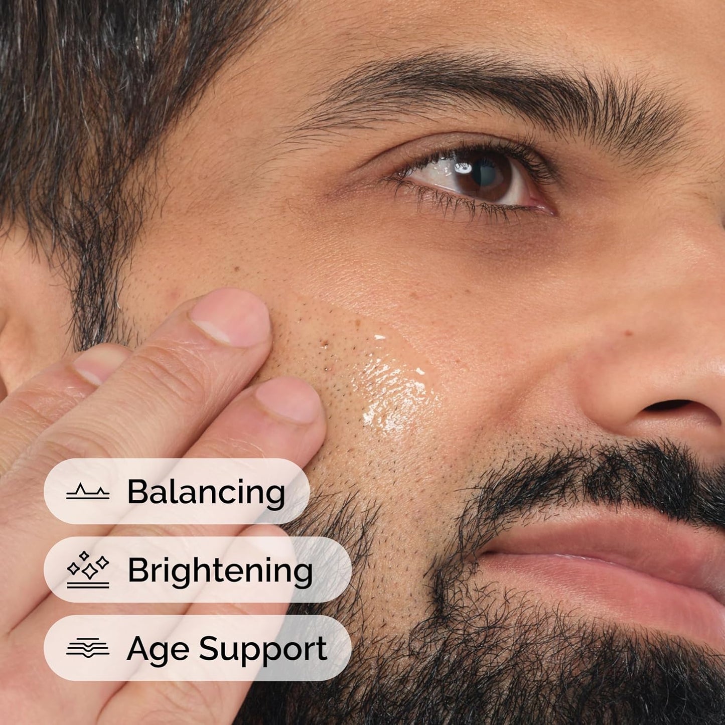 Close-up of a man's face with text indicating balancing, brightening, and age support benefits.