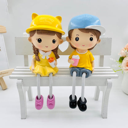 Kiss & Bouquet Gift Set Decorative Showpiece |Gift for him/her or Someone Special | Polyresin Couple Wearing Cute Caps Hanging Legs Showpiece - 2 Pcs Set