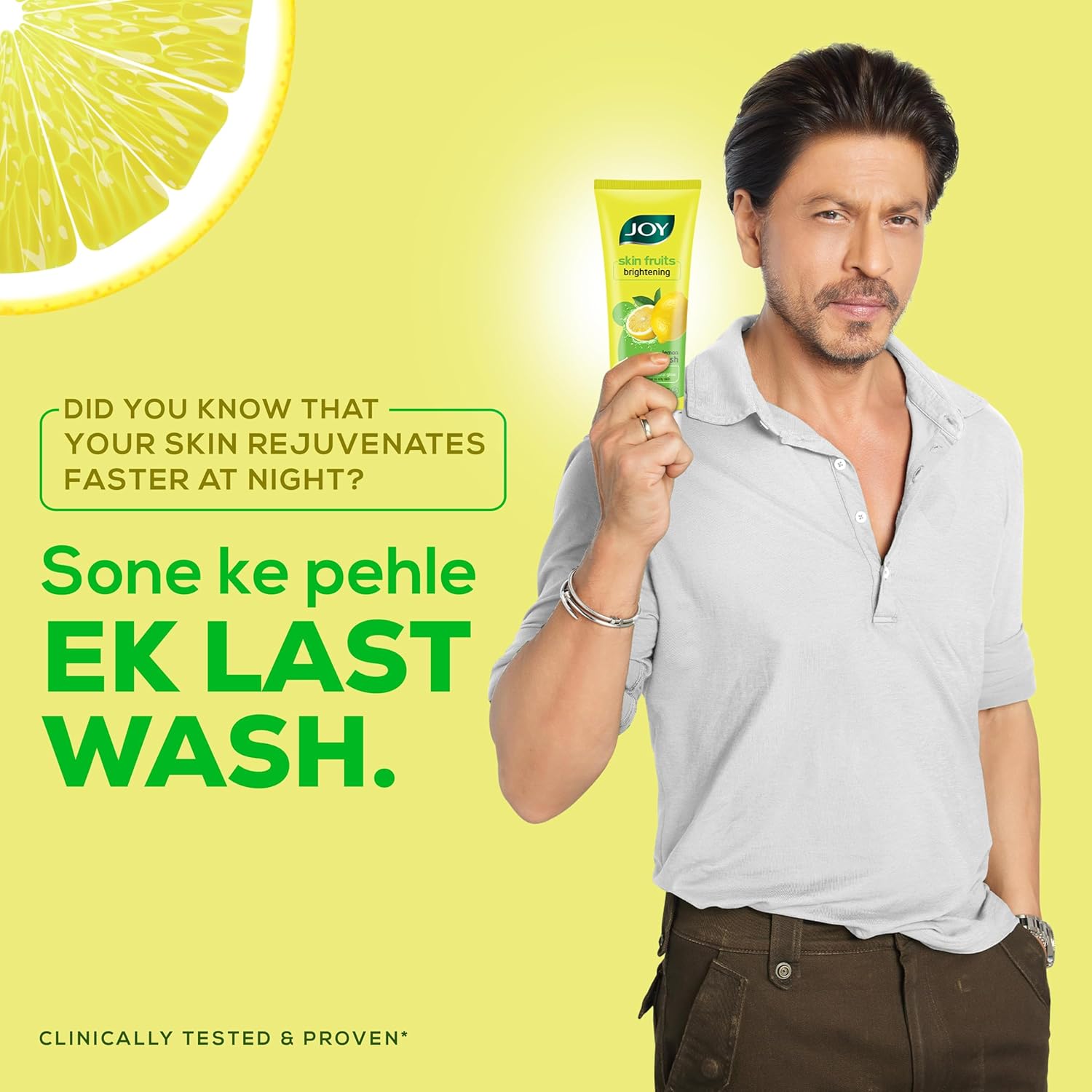 Man holding a tube of JOY product with lemon graphic and text on a yellow background