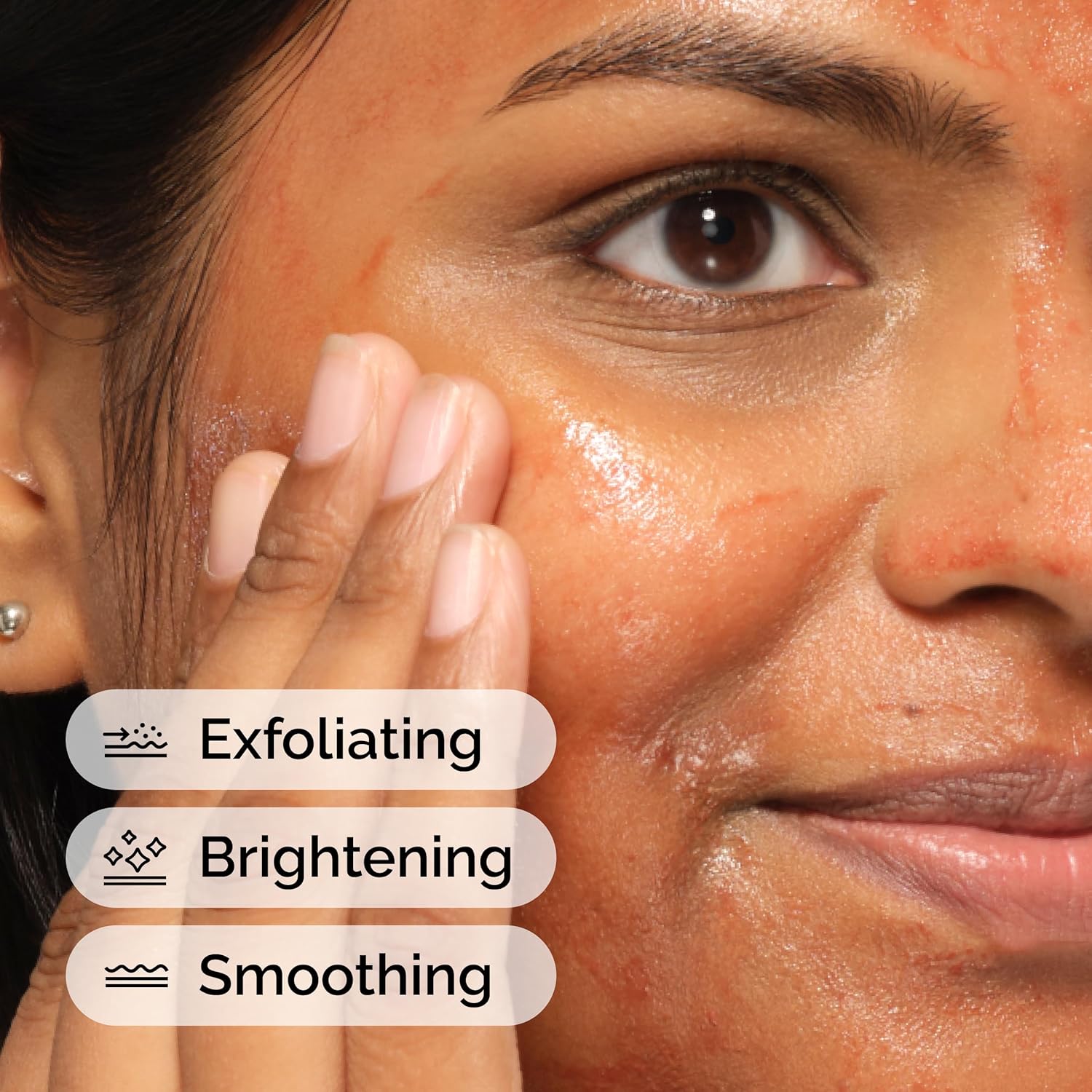 Close-up of a woman's face with text indicating exfoliating, brightening, and smoothing effects.