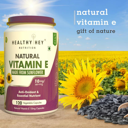 Healthy Hey Nutrition natural vitamin E supplement with sunflower field in the background