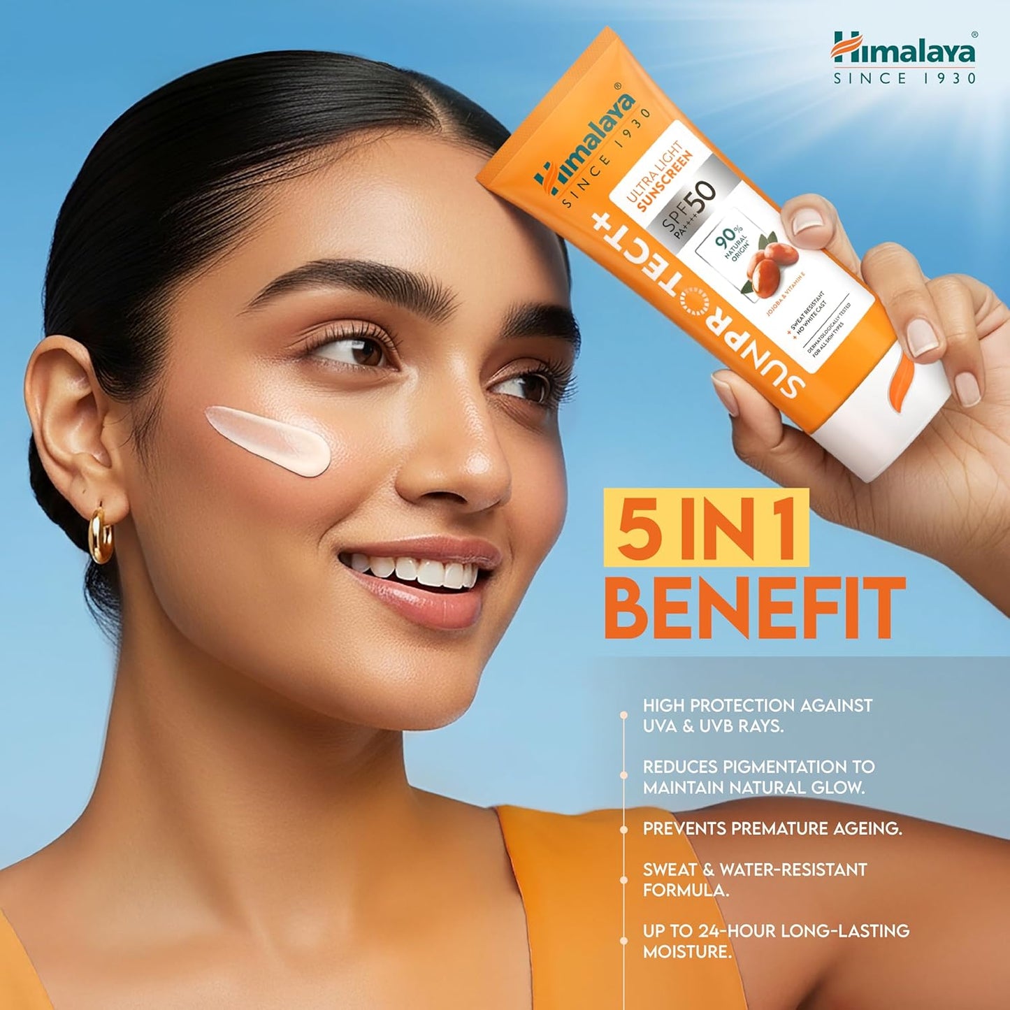 Woman applying sunscreen with a Himalaya Sun Protect+ tube against a blue background