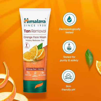 Himalaya Tan Removal Orange Face Wash tube on an orange background with product features highlighted.