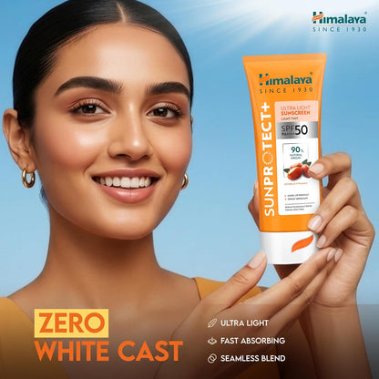 Woman holding a tube of Himalaya Sunscreen with a blue background