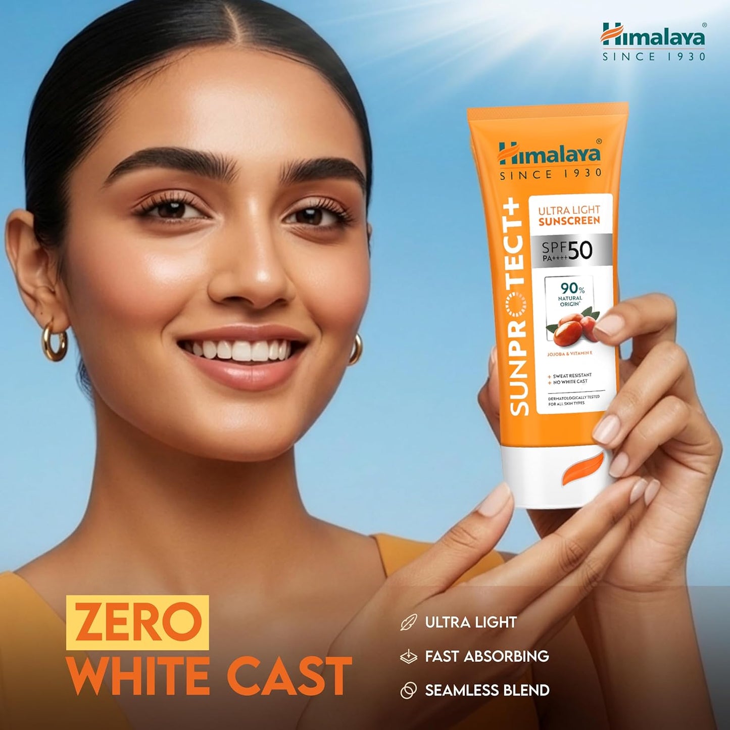 Woman holding a tube of Himalaya Sunscreen with a blue background
