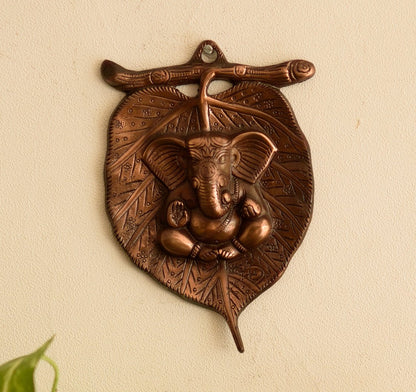 eCraftIndia Lord Ganesha on Leaf Wall Hanging (13.75 cm x 1.25 cm x 21.25 cm, Brown)