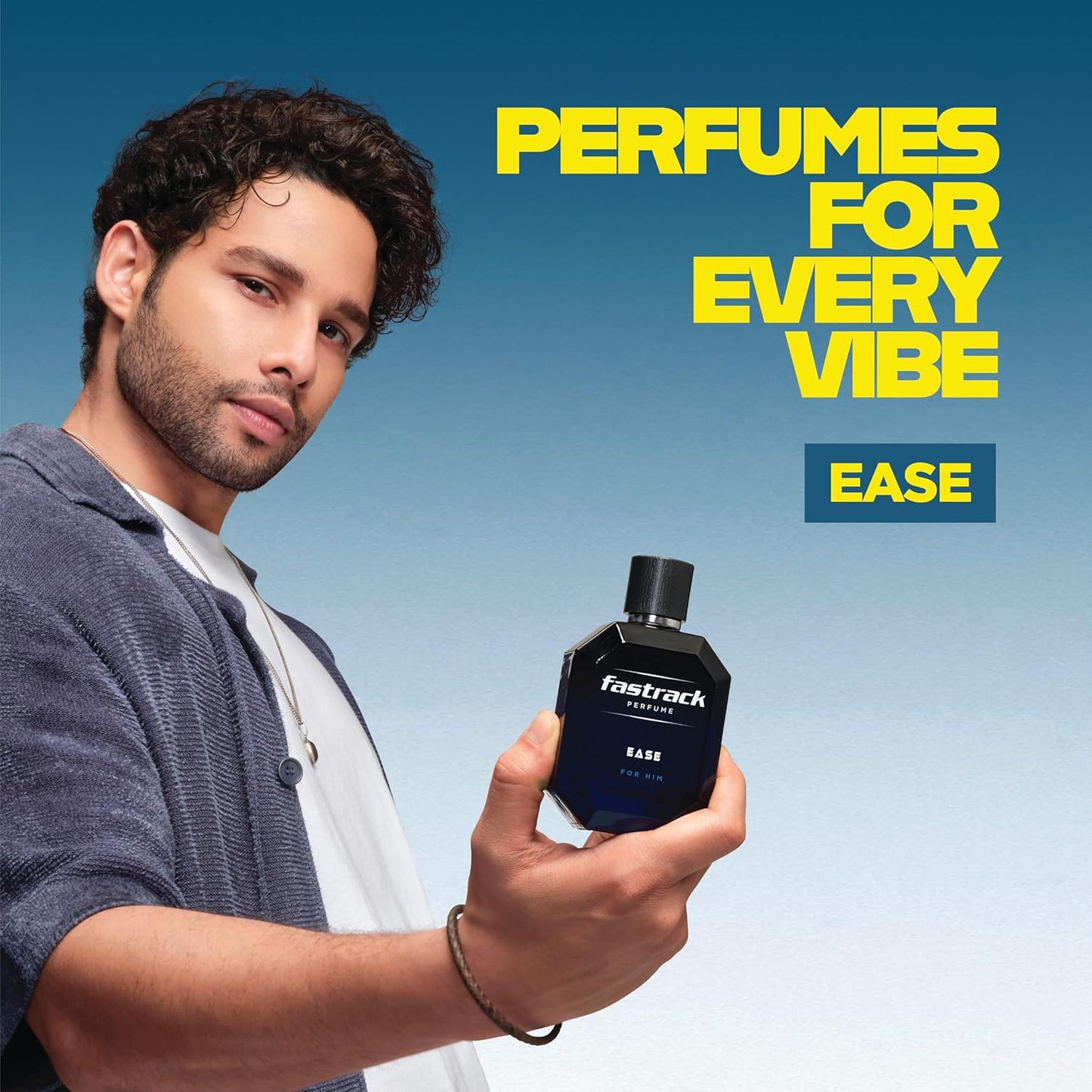 Man holding a Fastrack perfume bottle with 'Perfumes for Every Vibe Ease' text on a blue background