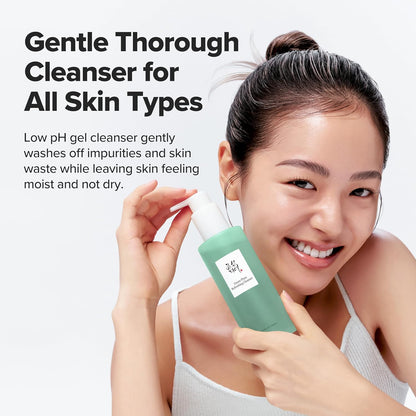Woman holding a green cleanser bottle with text about gentle cleansing for all skin types.