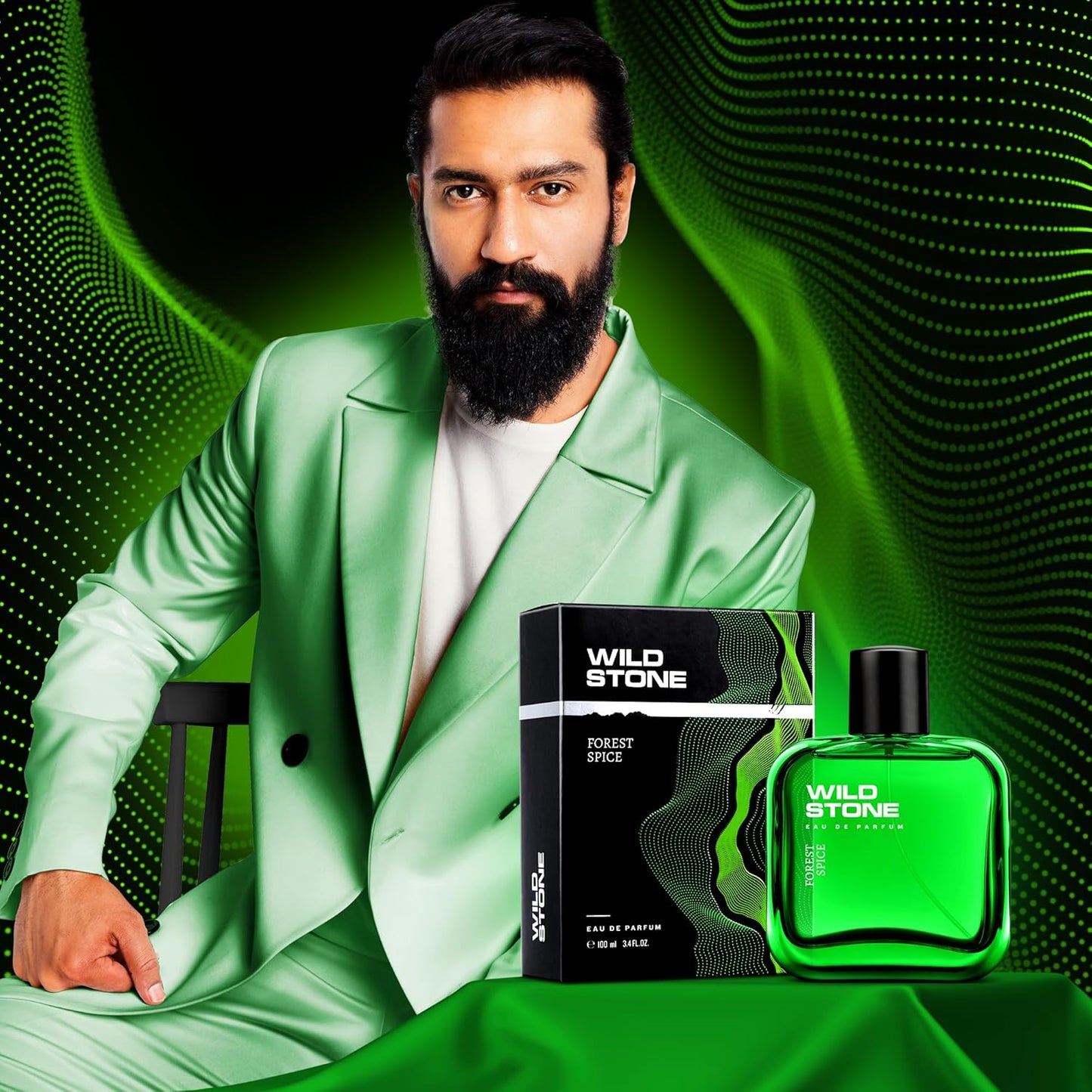 Man in a green suit with Wild Stone perfume bottles and packaging on a green background