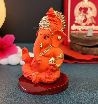 Handcrafted Poly Resin Ganesha Statue with Base - Perfect for Car Dashboard, Office Desk, Shelves, and Home Decor - Ideal Housewarming Gift! (OrangeMukutwithbase)