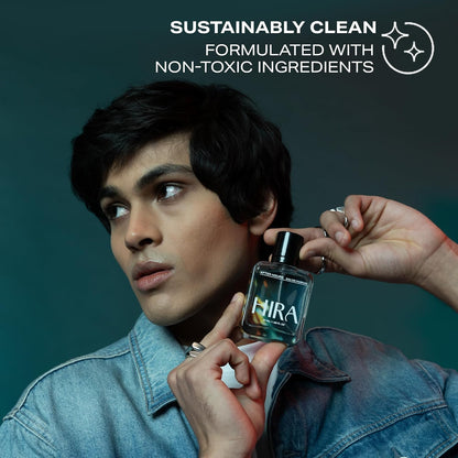 Person applying HIRA perfume with 'Sustainably Clean' text on a dark background