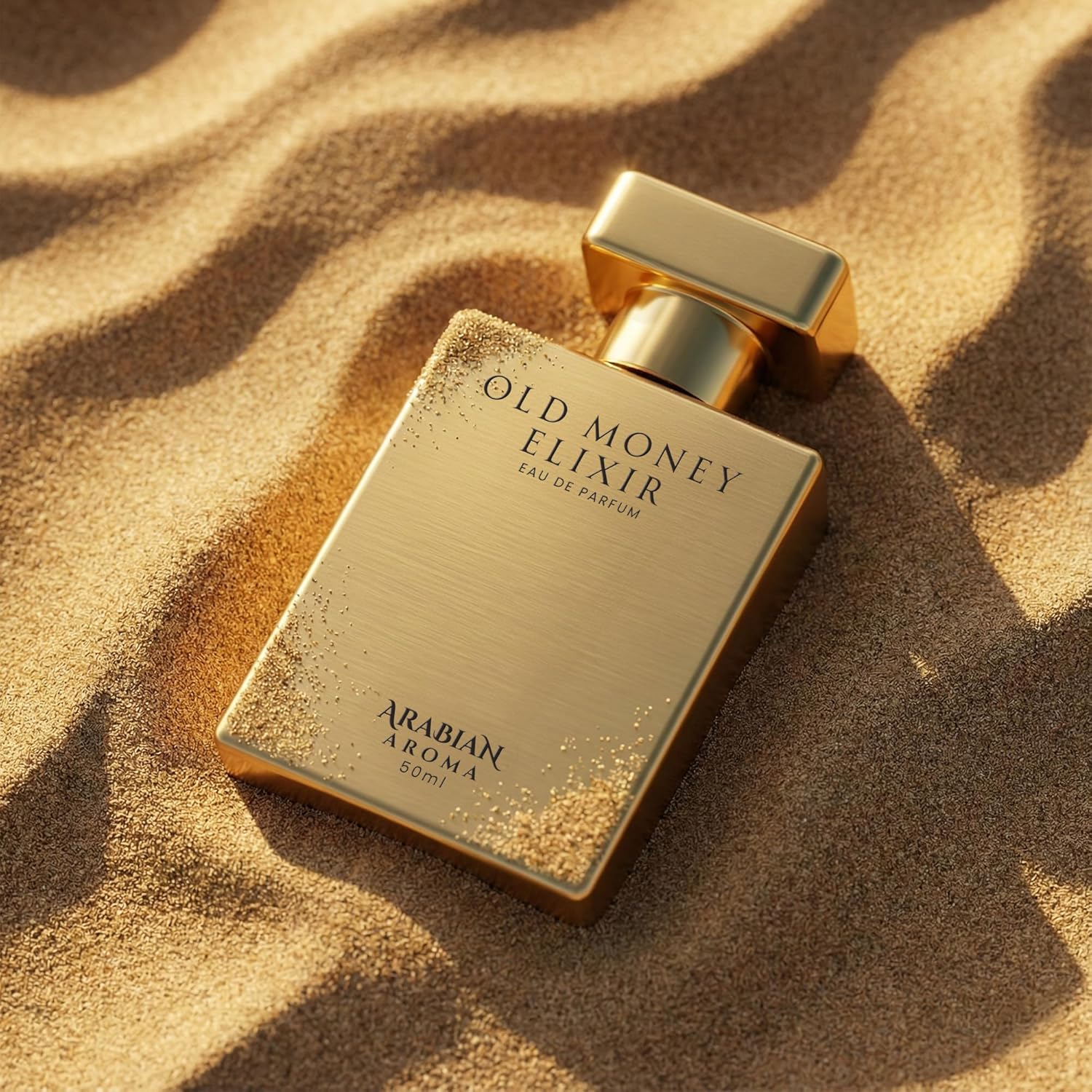 Gold perfume bottle labeled 'Old Money Elixir' on sand