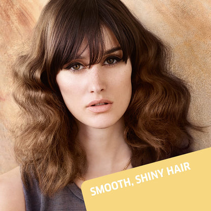 Woman with smooth, shiny hair against a beige background