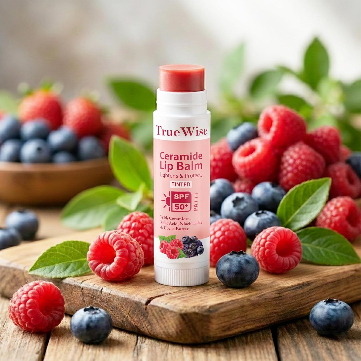True Wise Ceramide Lip Balm with SPF 50 surrounded by berries on a wooden surface