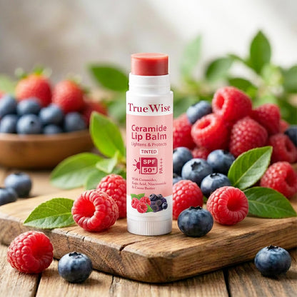 True Wise Ceramide Lip Balm with SPF 50 surrounded by berries on a wooden surface