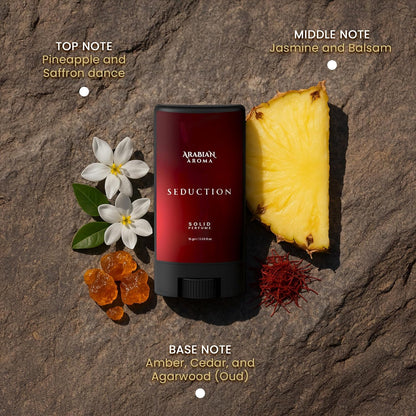 Solid perfume stick with pineapple, flowers, and spices on a stone background