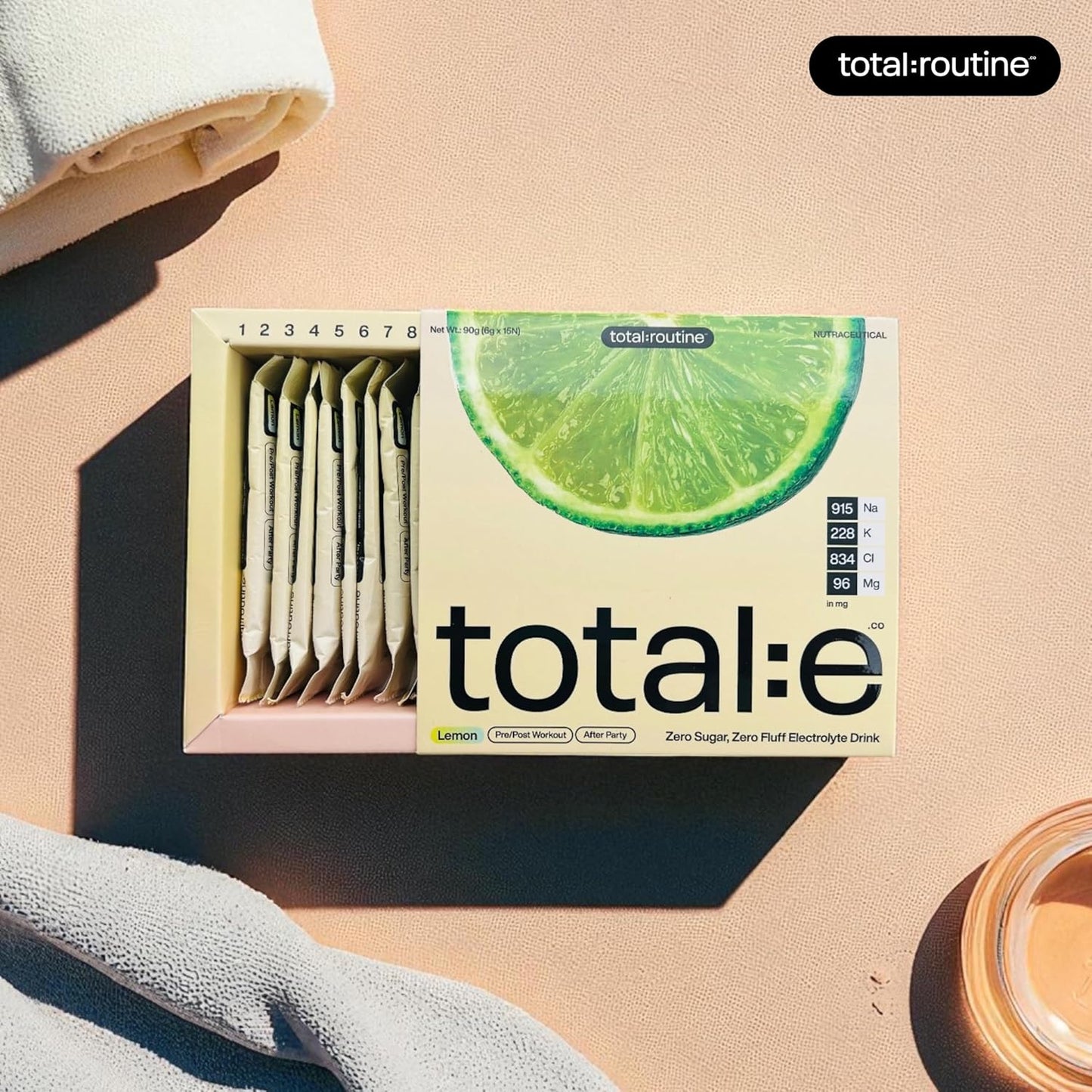 total:e electrolyte drink mix box with lemon flavor on a beige background