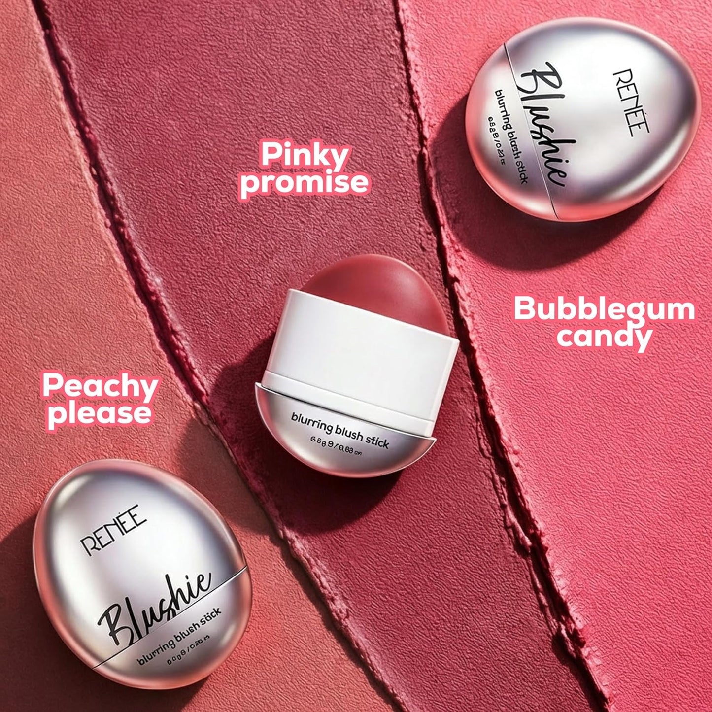 Three REVEE Blushie blurring blush sticks on a pink background with names of shades.
