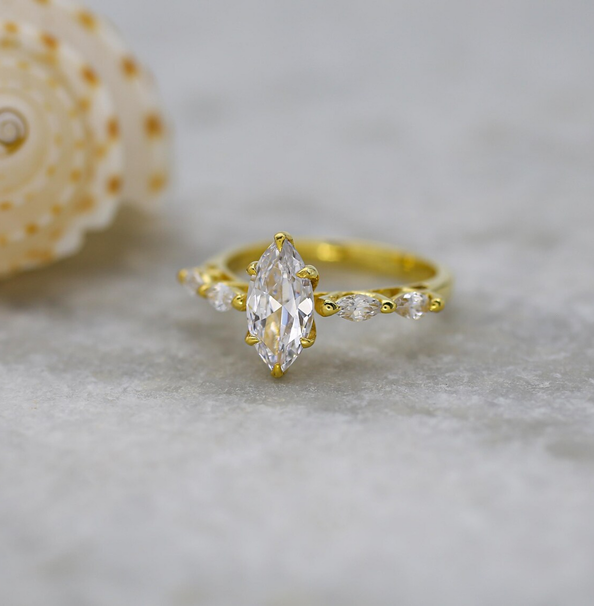 Gold ring with a large diamond on a textured surface