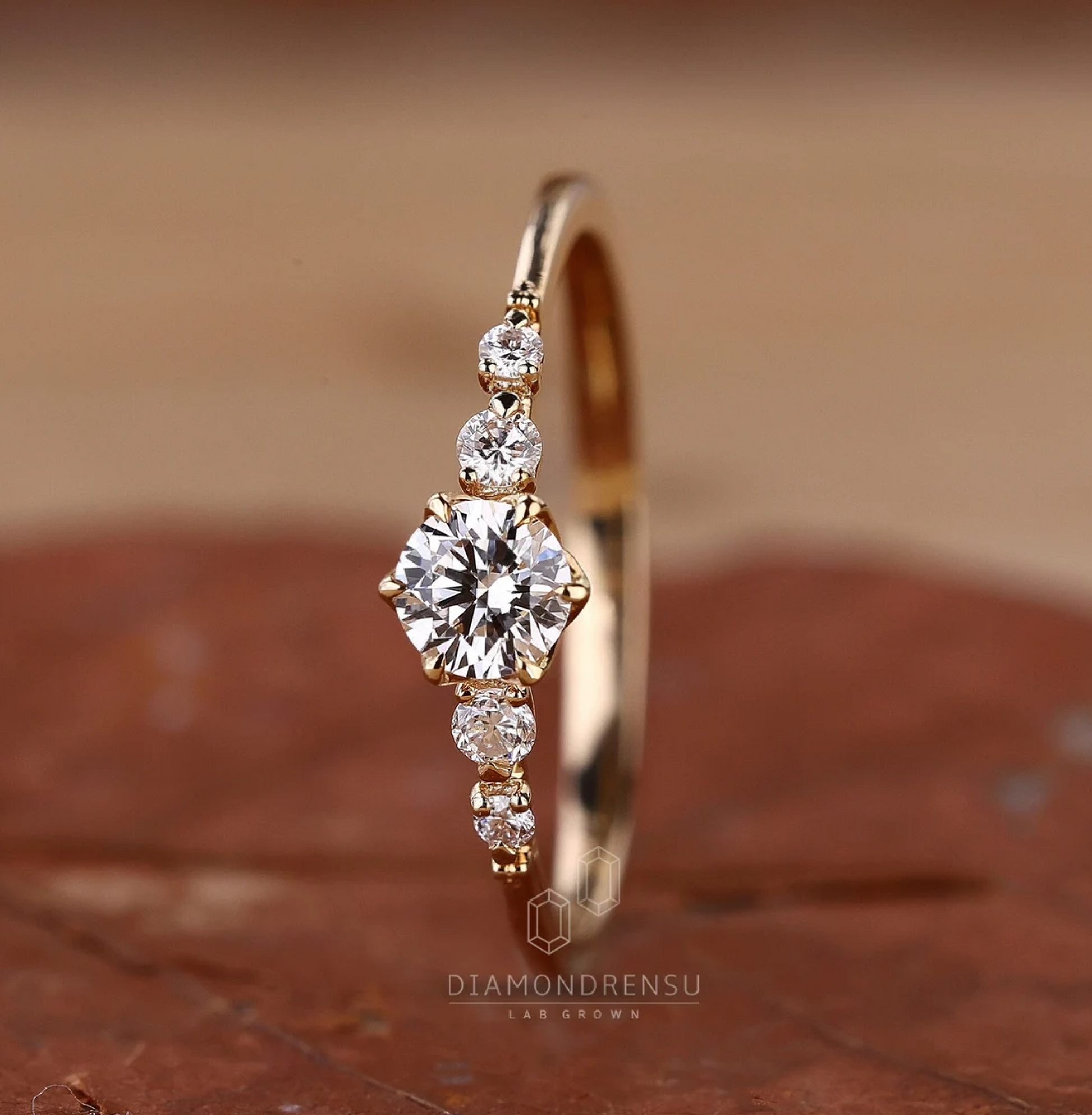 Gold ring with diamonds on a brown surface