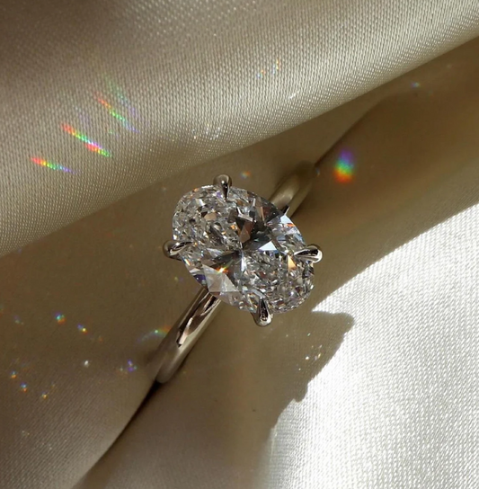 Diamond ring on a light fabric background