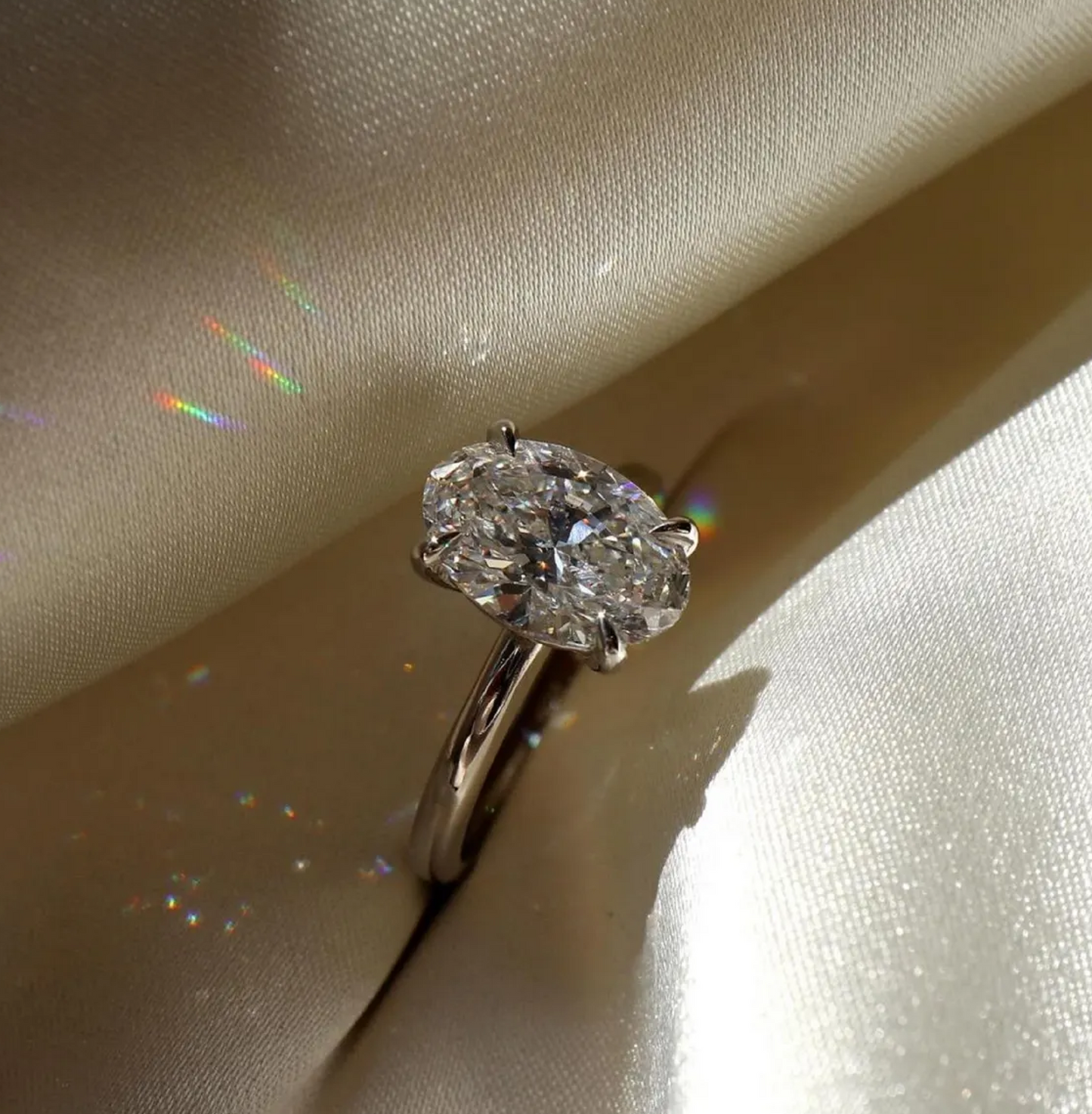 Diamond ring on a soft beige fabric background