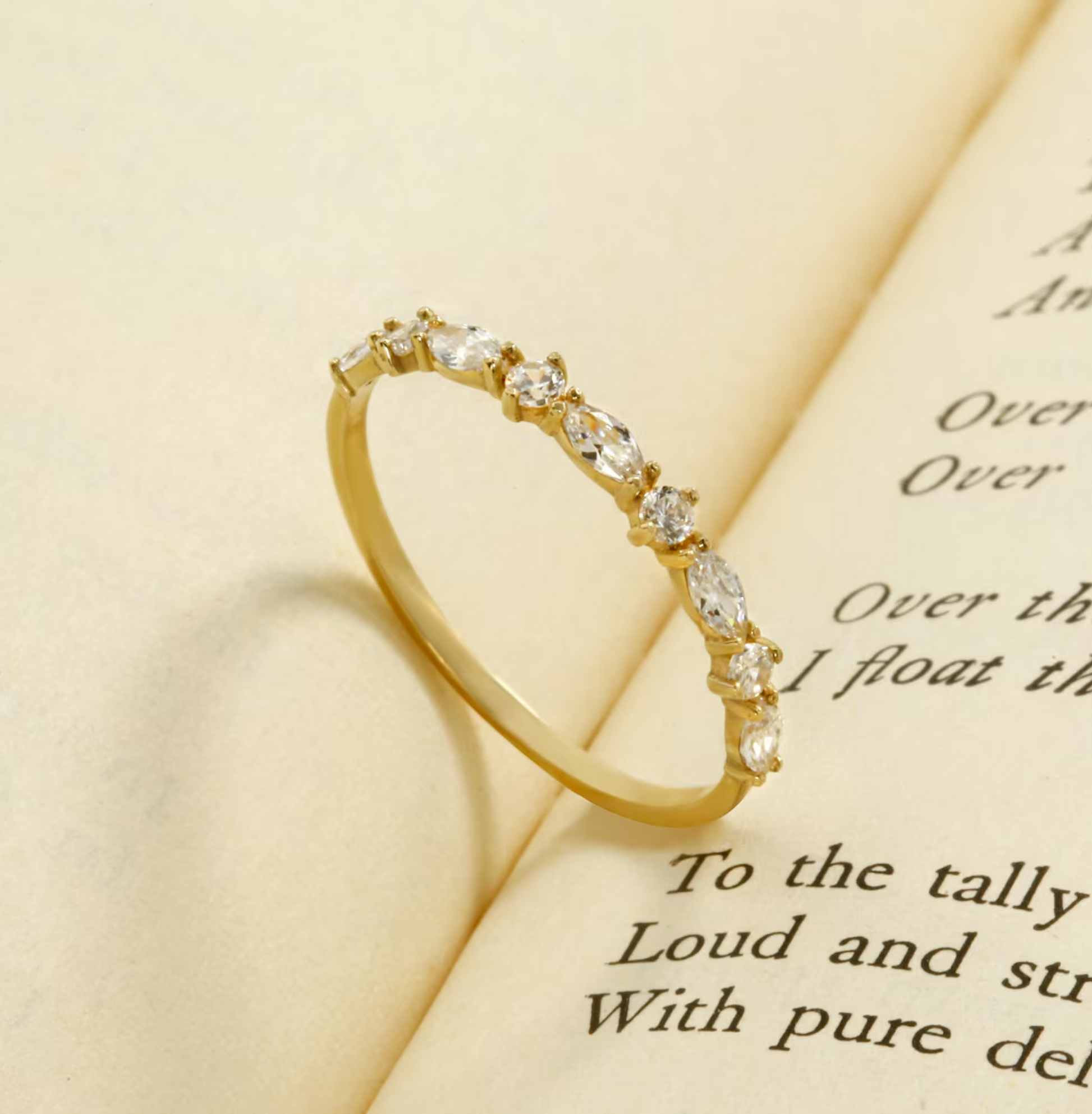 Gold ring with diamonds on a piece of paper