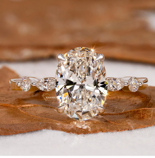 Diamond ring with a large central gemstone on a wooden surface