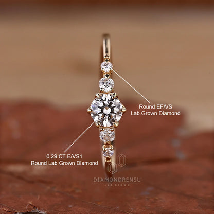Gold ring with lab-grown diamonds on a brown background