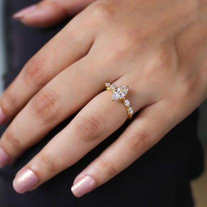 Gold ring with a diamond on a person's finger against a dark background