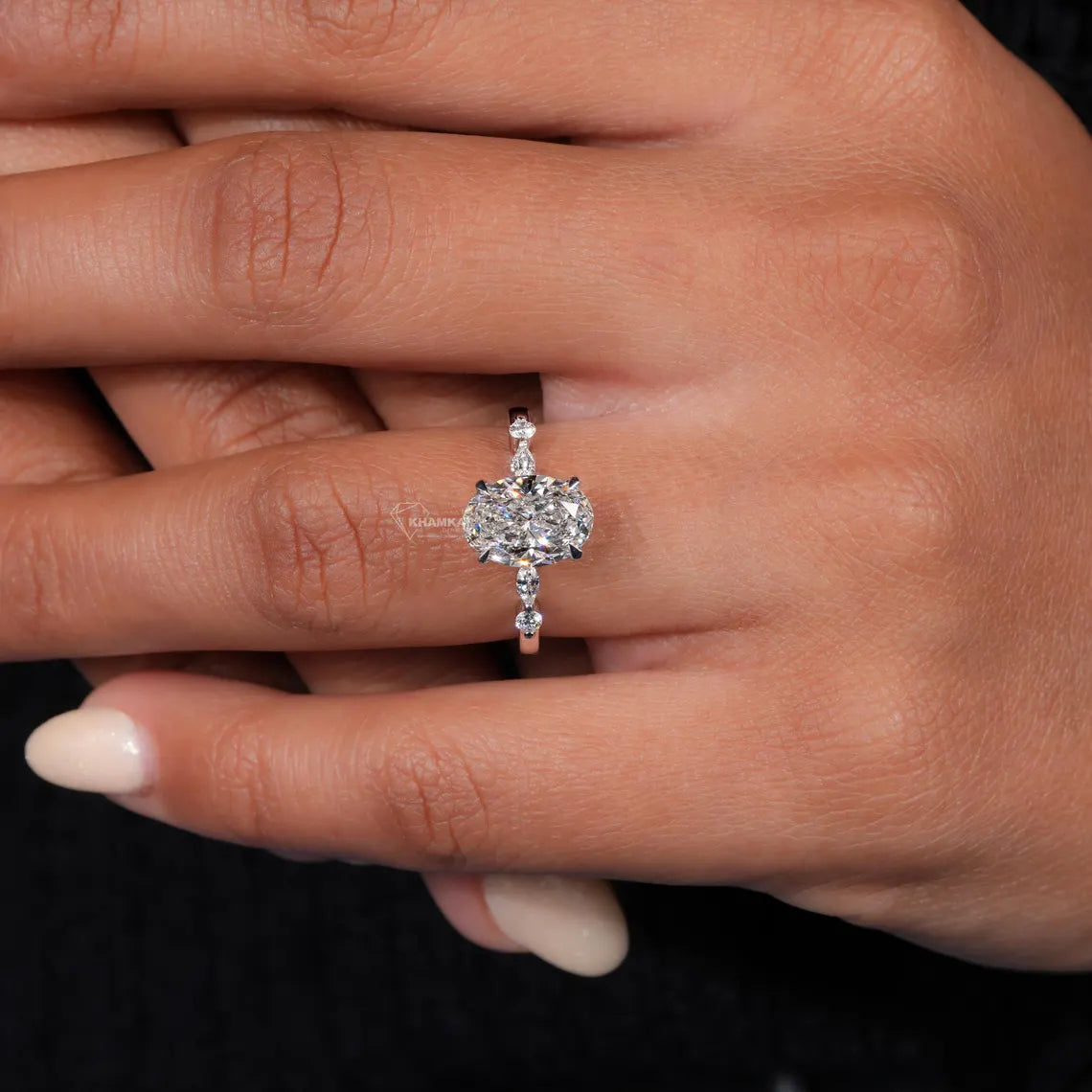 Diamond ring on a finger with a blurred background