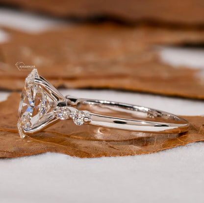 Diamond ring with a triangular cut stone on a brown leaf