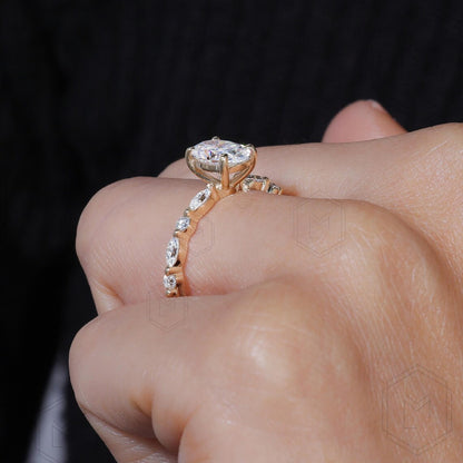 Rose gold diamond ring on a hand against a dark background