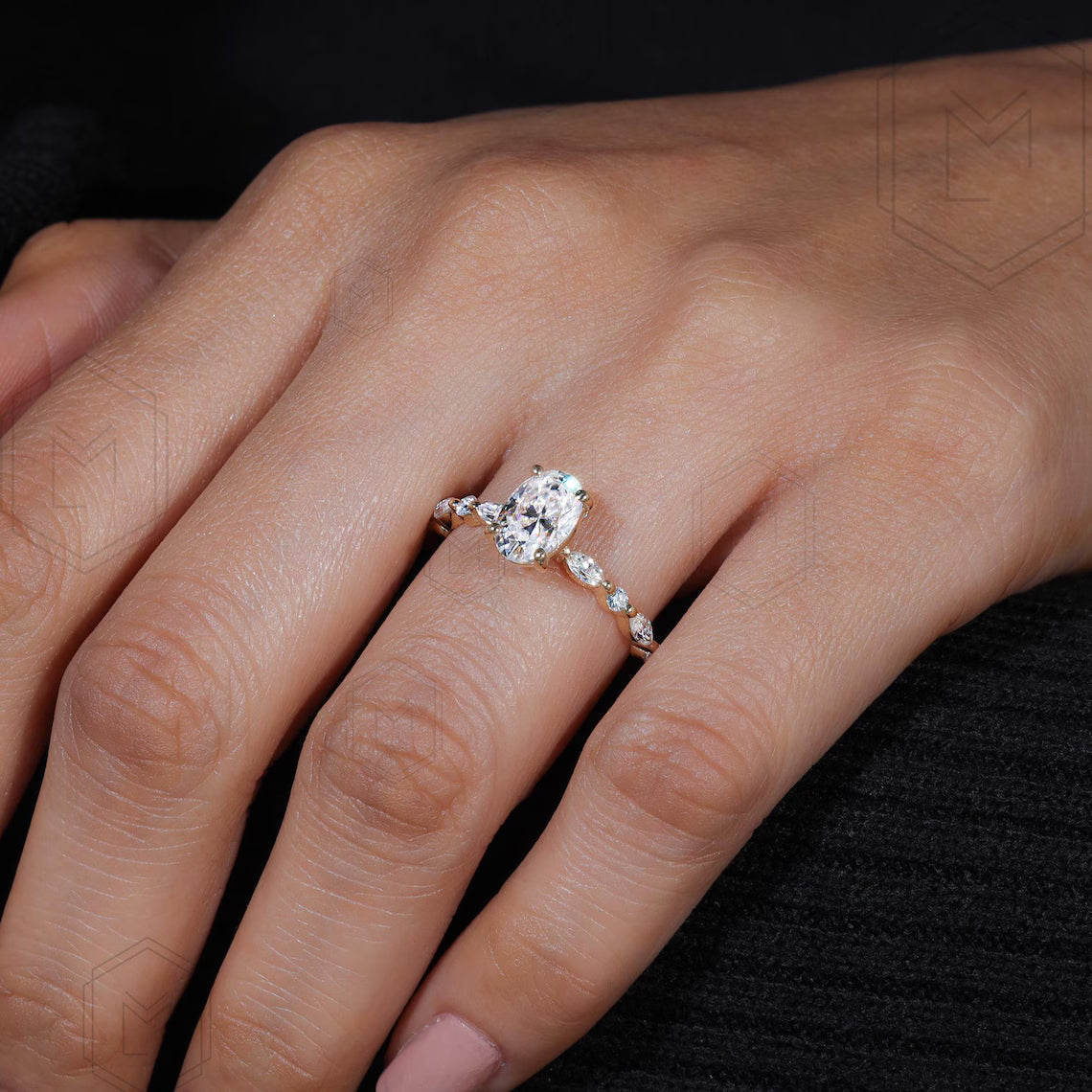 Close-up of a hand wearing a diamond ring on a dark background