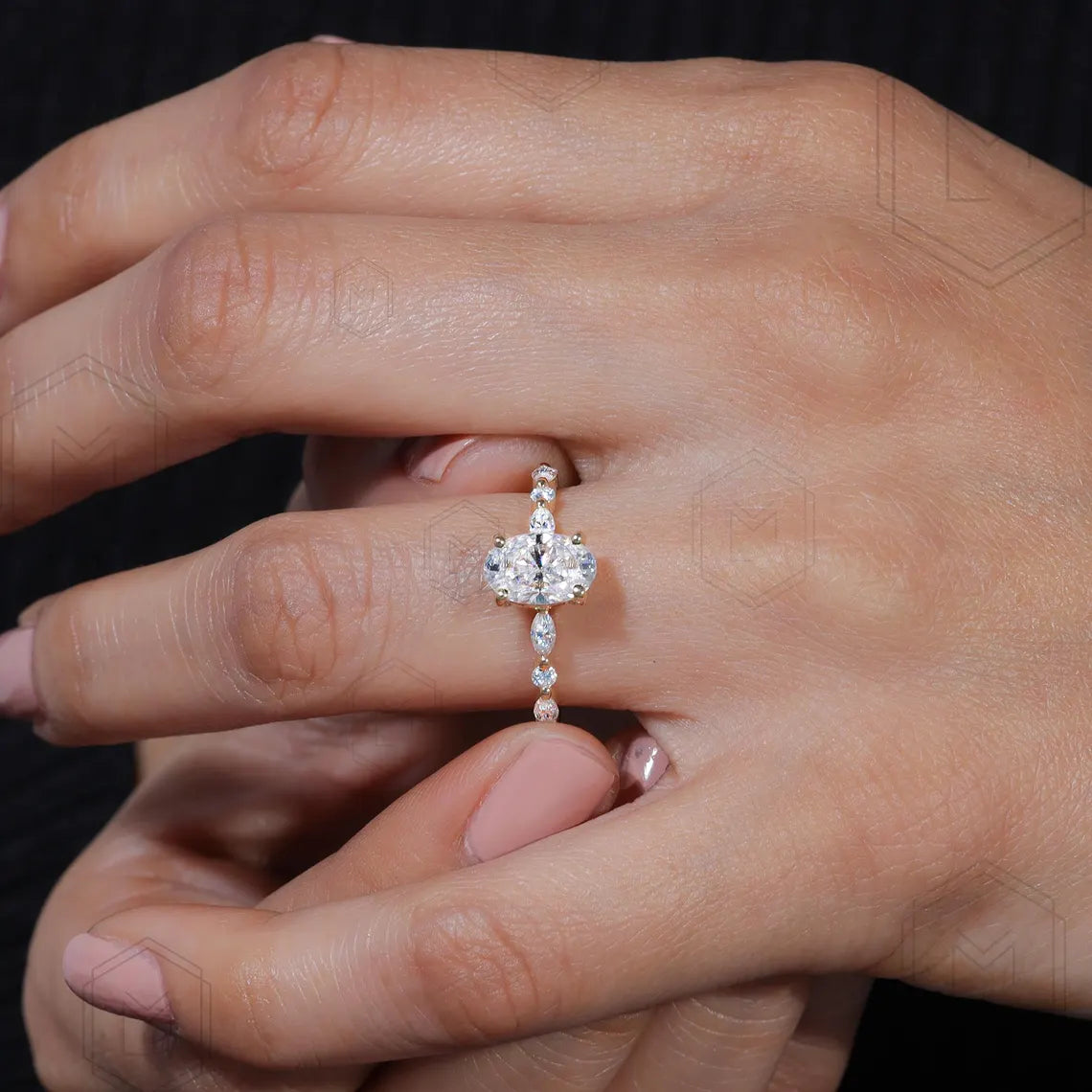 Close-up of a hand wearing a diamond ring with a black background