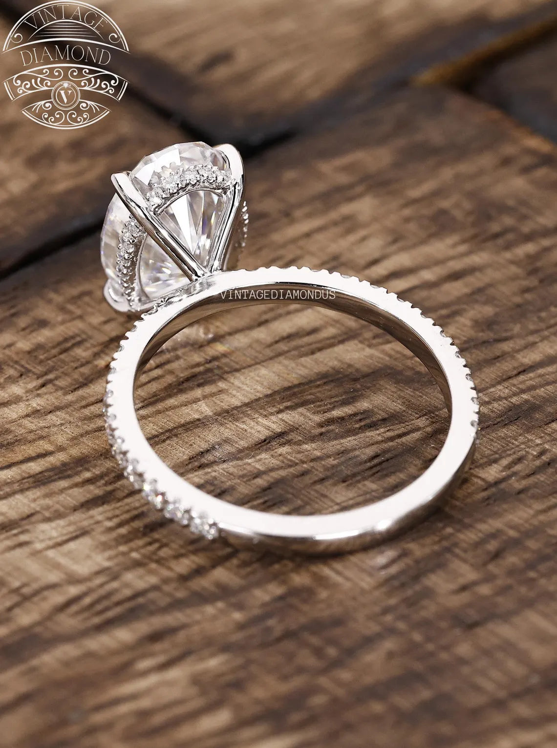 Diamond ring on a wooden surface with 'Vintage Diamond' branding.