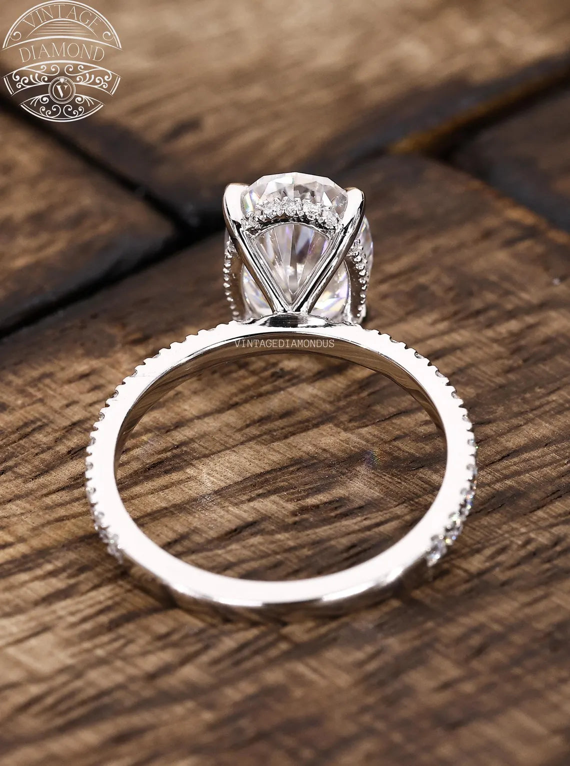 Silver diamond ring on a wooden surface with 'Lancaster Diamond' logo.