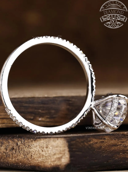 Silver ring with diamond on a wooden surface, featuring Vintage Diamond logo.