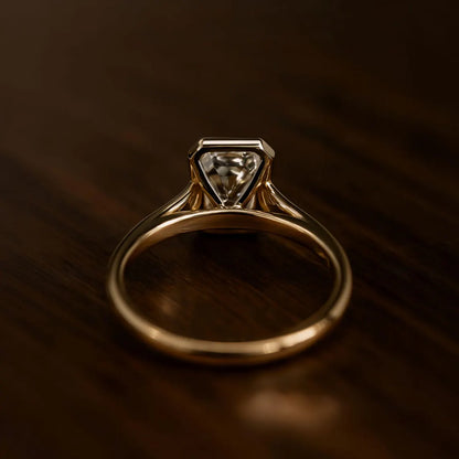 Gold ring with a diamond on a dark brown background