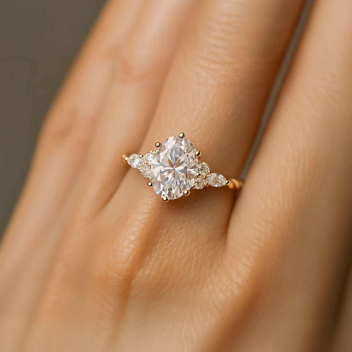 Diamond ring on a person's finger with a neutral background