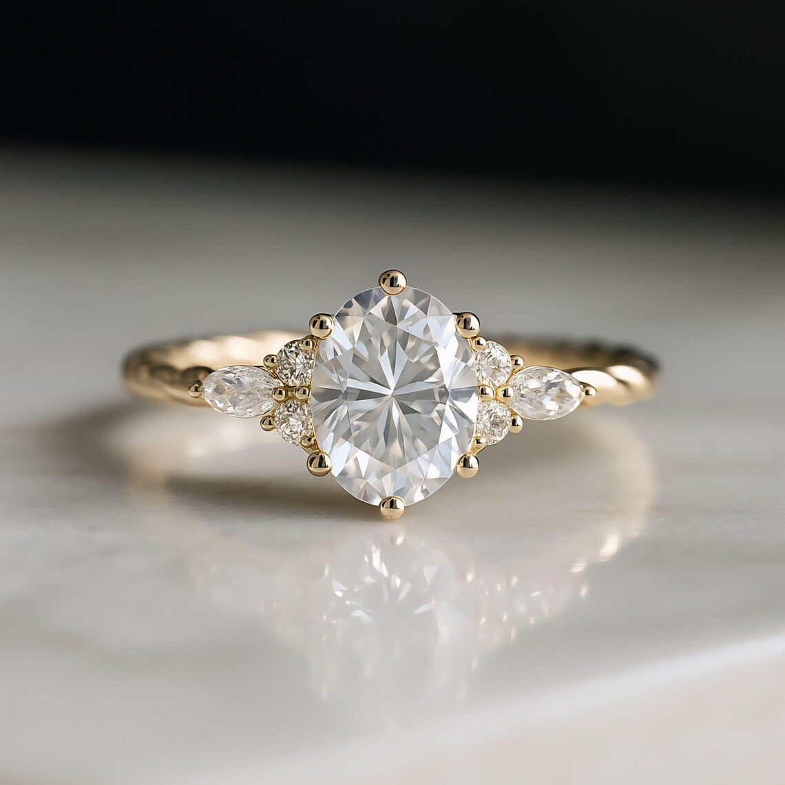 Gold ring with a large diamond and smaller diamonds on a reflective surface