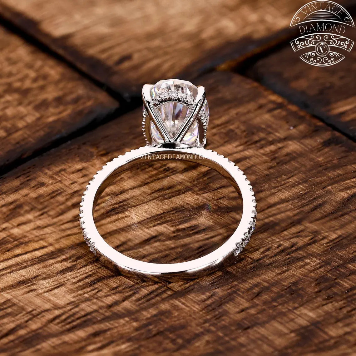 Diamond ring on a wooden surface with 'Diamonds' logo in the corner