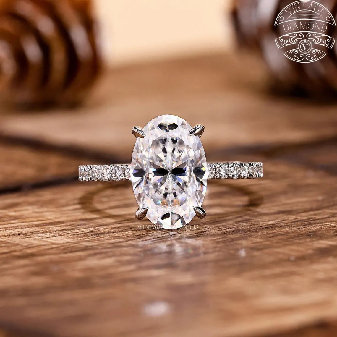 Diamond ring with a large central gemstone on a wooden surface, featuring the 'Vintaj' brand.